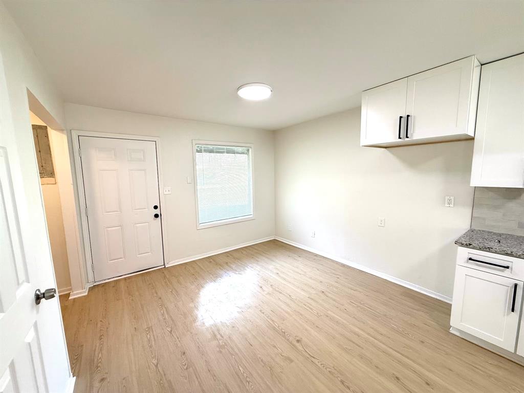 1401 Arvel Circle Azle, TX 76020 - Photo 6 of 26 an empty room with wooden floor and windows