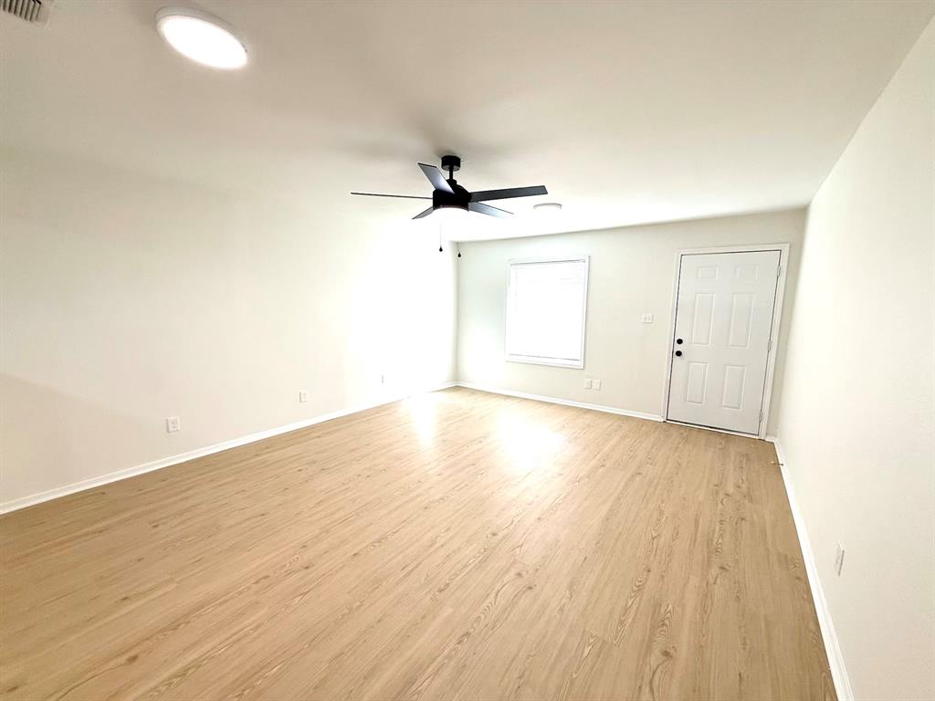 1401 Arvel Circle Azle, TX 76020 - Photo 8 of 26 an empty room with wooden floor and ceiling fan
