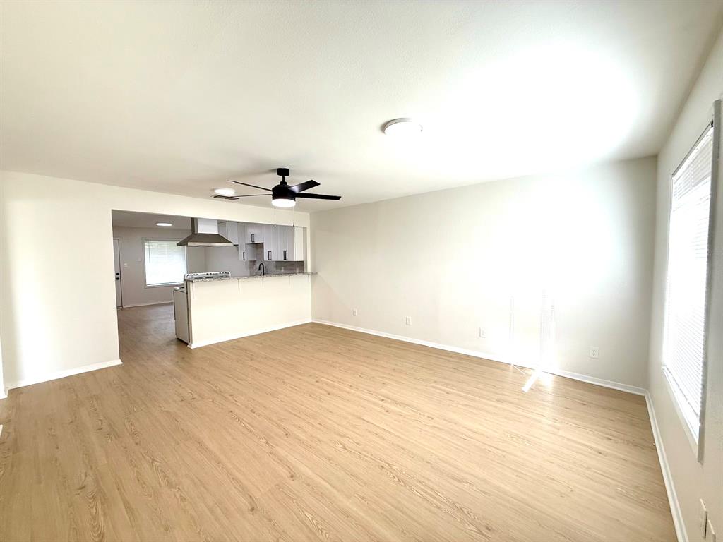1401 Arvel Circle Azle, TX 76020 - Photo 9 of 26 a view of empty room with wooden floor and kitchen