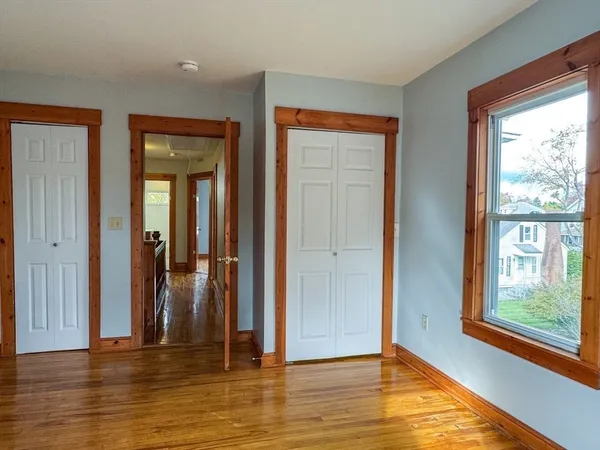 a view of a room with wooden floor and windows