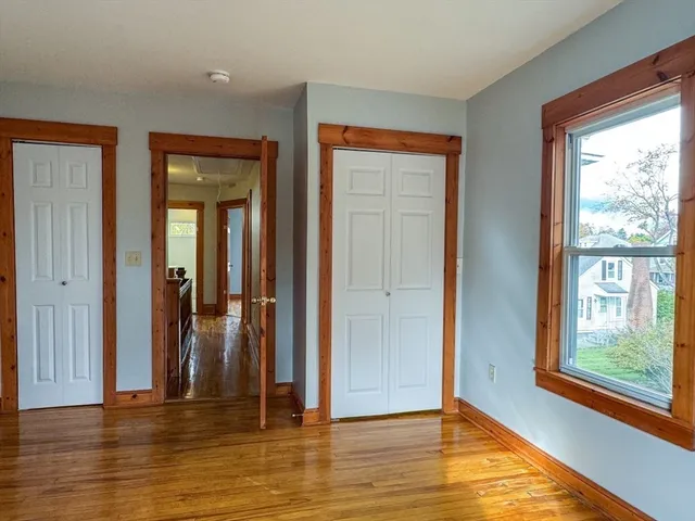 a view of a room with wooden floor and windows