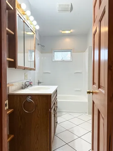 a bathroom with a sink a mirror and a bathtub