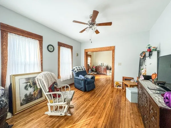 a living room with furniture and a wooden floor