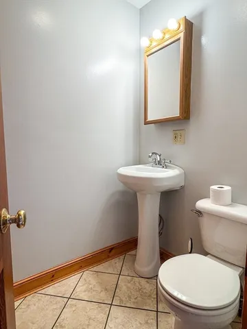 a bathroom with a sink toilet and mirror