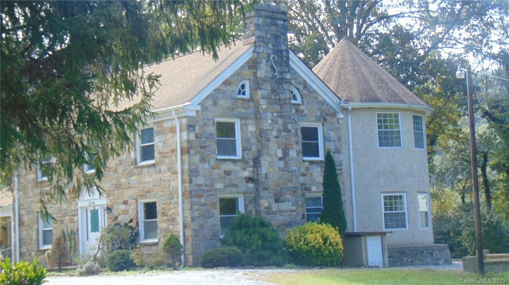 3516 Brevard Road Hendersonville, NC 28791 - Photo 2 of 20 a front view of a house with garden
