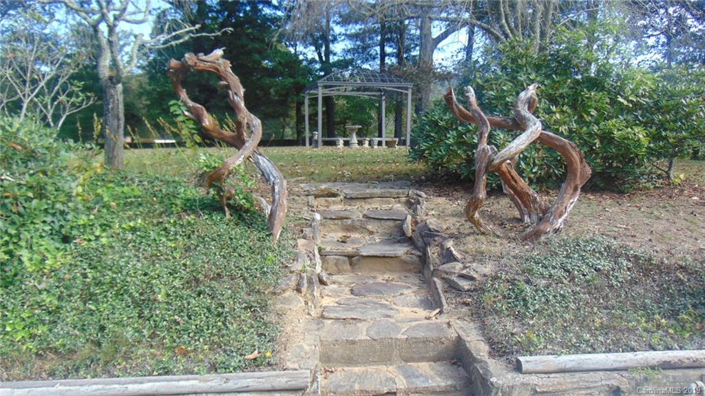 3516 Brevard Road Hendersonville, NC 28791 - Photo 15 of 20 a front view of a house with garden