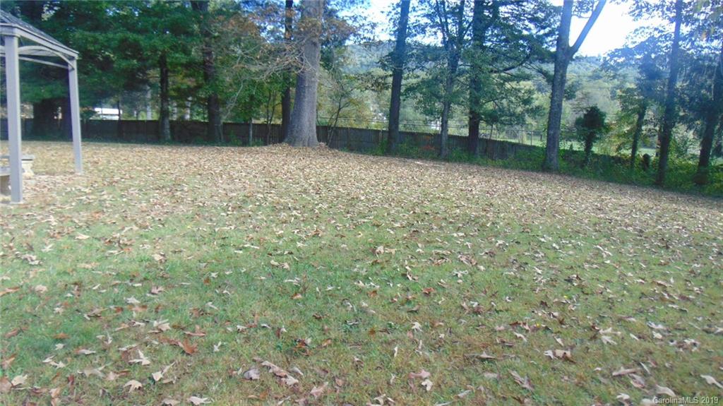 3516 Brevard Road Hendersonville, NC 28791 - Photo 18 of 20 a backyard of a house with lots of green space