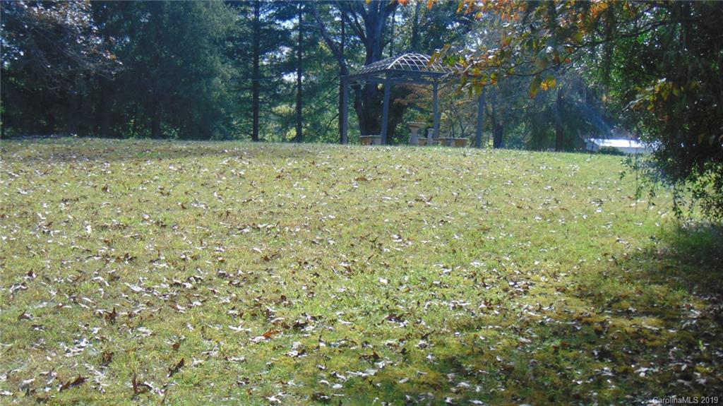 3516 Brevard Road Hendersonville, NC 28791 - Photo 20 of 20 a view of a yard with a tree