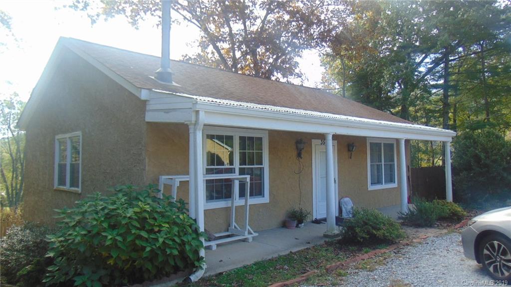 3516 Brevard Road Hendersonville, NC 28791 - Photo 3 of 20 a front view of a house with garden