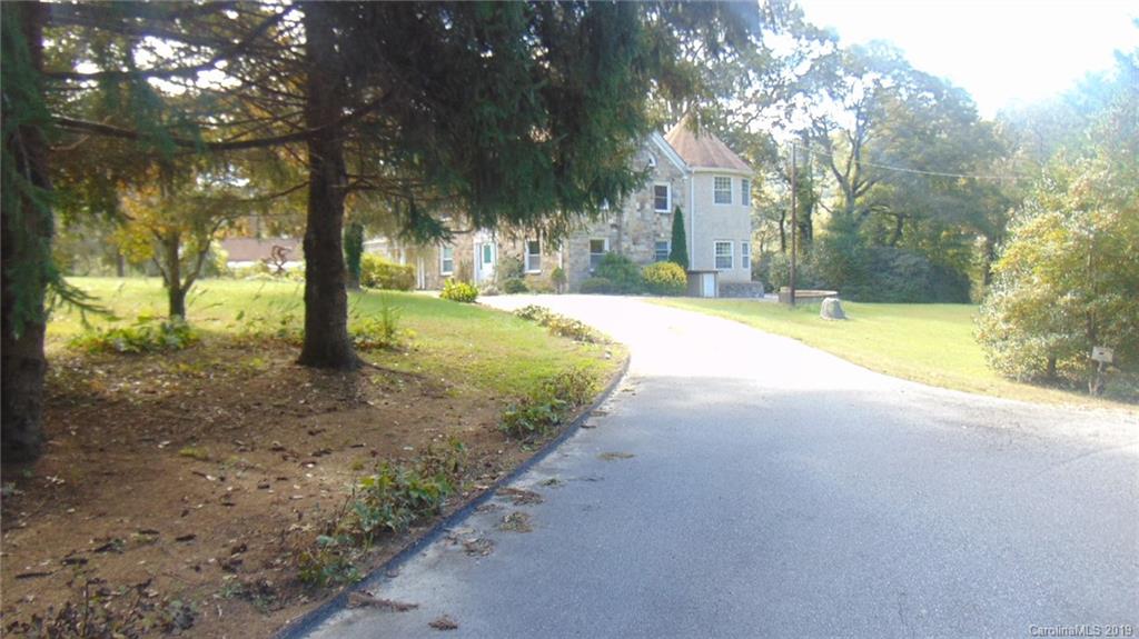 3516 Brevard Road Hendersonville, NC 28791 - Photo 4 of 20 a view of a yard with a tree