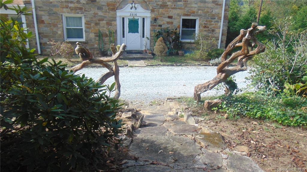 3516 Brevard Road Hendersonville, NC 28791 - Photo 9 of 20 a backyard of a house with table and chairs