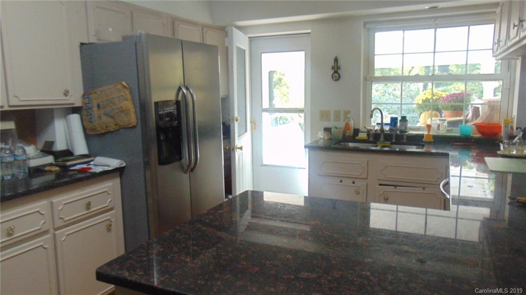 3516 Brevard Road Hendersonville, NC 28791 - Photo 10 of 20 a kitchen with stainless steel appliances granite countertop a refrigerator and a sink