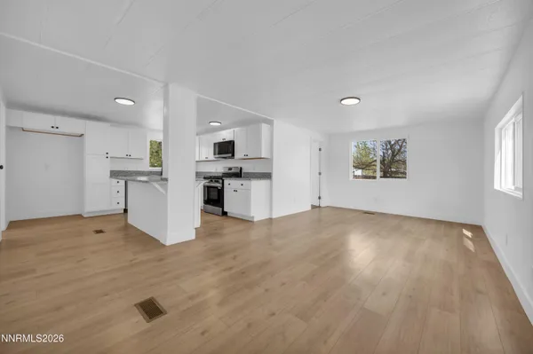 a view of kitchen with wooden floor and electronic appliances