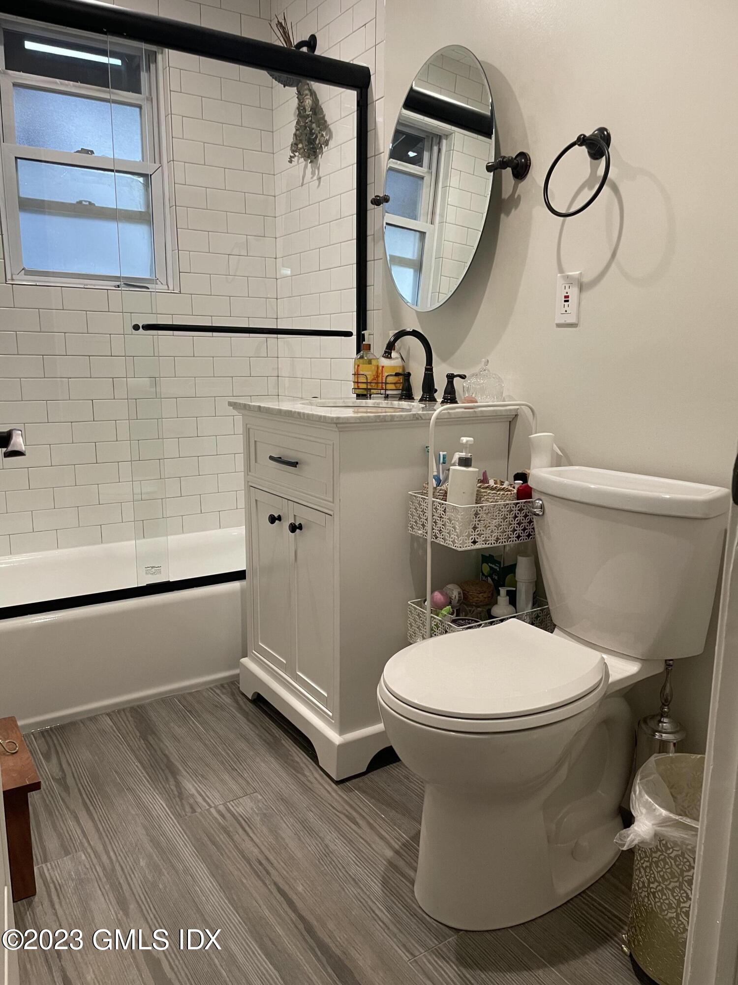 60 Weaver Street, Unit 2 Greenwich, CT 06831 - Photo 13 of 20 a bathroom with a toilet and a mirror