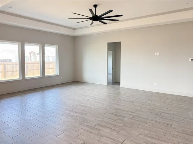 a large white kitchen with cabinets