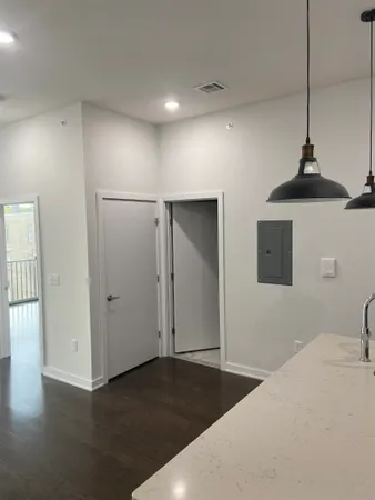 a bedroom with a bed and a chandelier fan