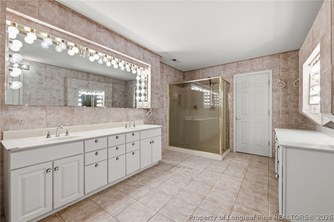 478 Rattlesnake Trail Aberdeen, NC 28315 - Photo 33 of 44 a bathroom with a double vanity sink mirror and shower