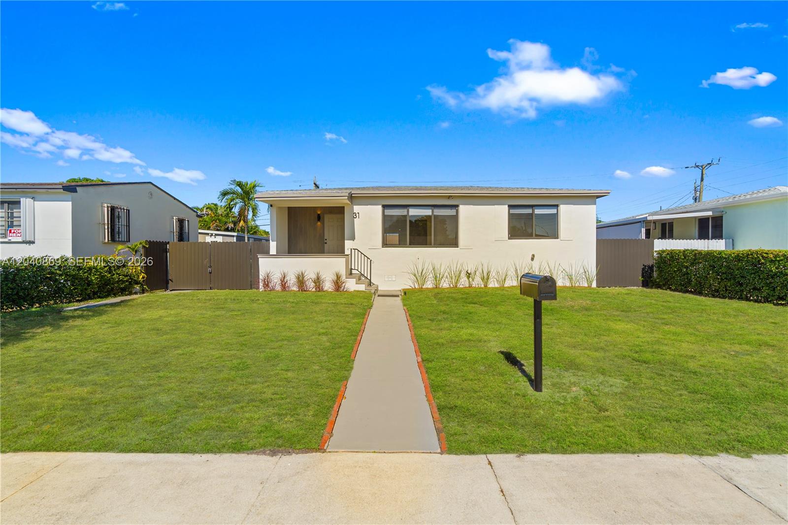 31 West 64th Street Hialeah, FL 33012 - Photo 2 of 49 a view of a house with a backyard