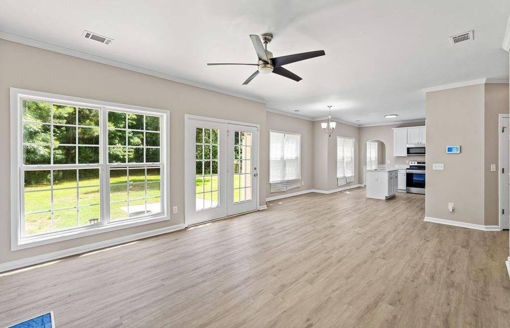 473 Greyhawk Way Fairburn, GA 30213 - Photo 14 of 34 a view of an empty room with a window and wooden floor