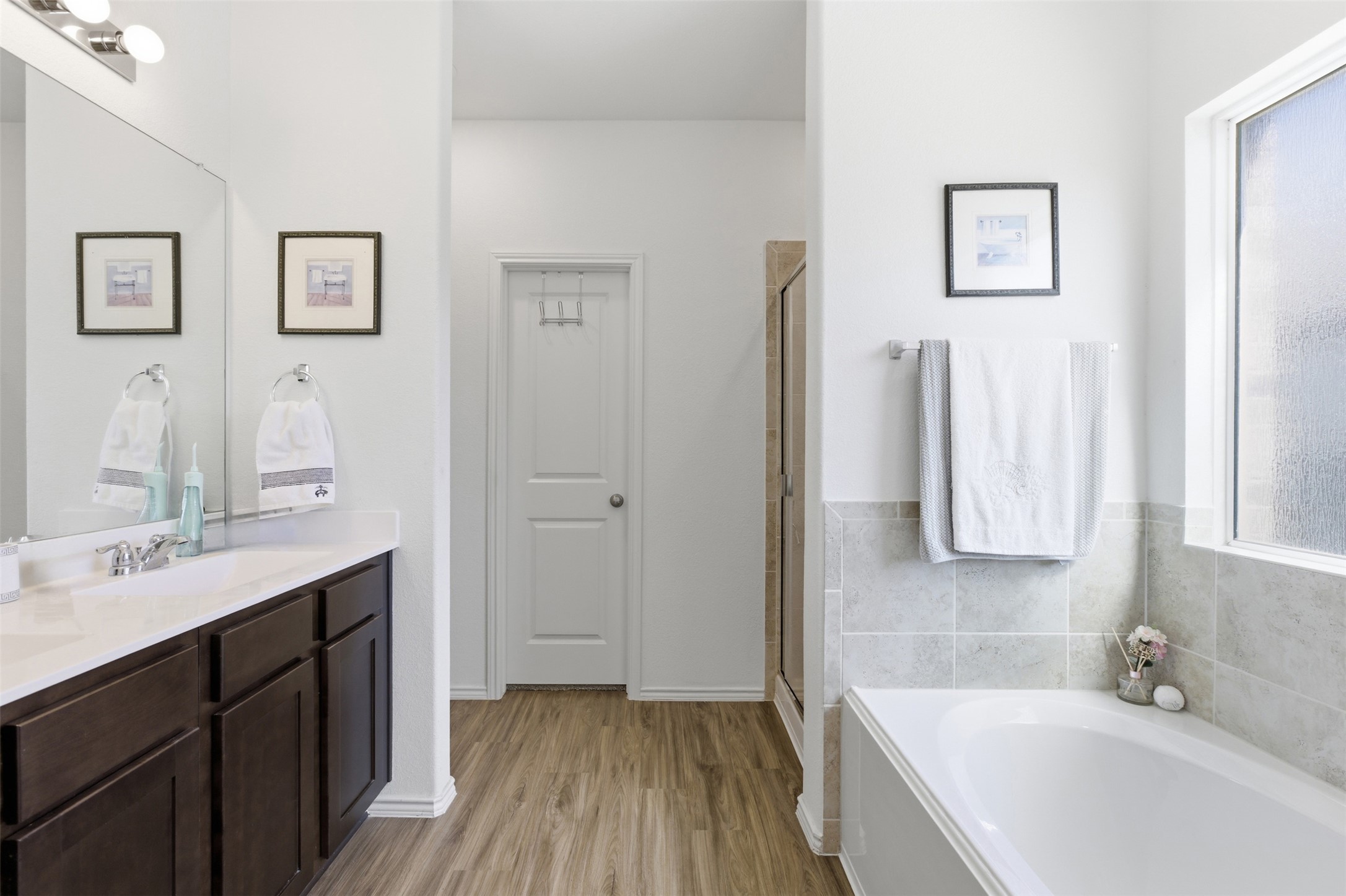832 Mallow Road Leander, TX 78641 - Photo 14 of 29 Full bath featuring double vanity, a bath, light wood-style flooring, and a stall shower