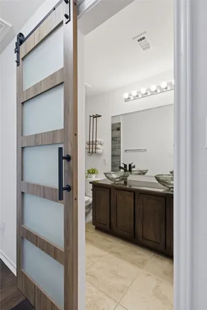 a spacious bathroom with a double vanity sink and a mirror