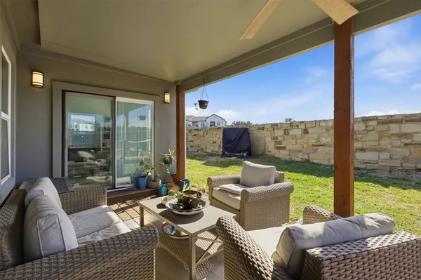 a living room with furniture and a floor to ceiling window