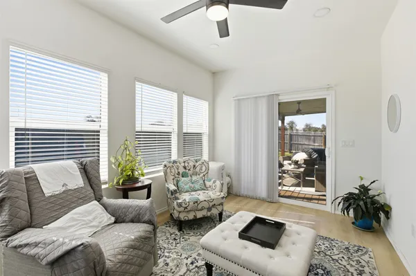 a living room with furniture and floor to ceiling windows