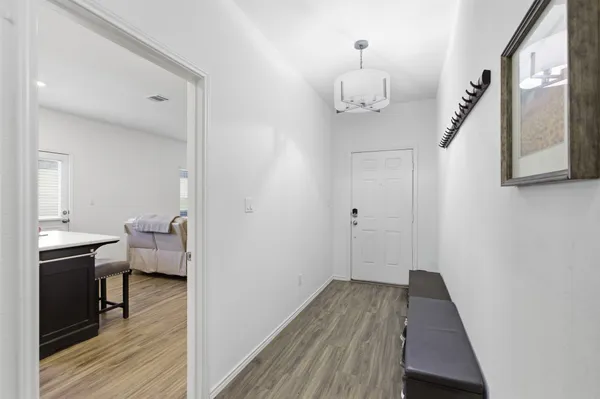 a view of a hallway view with wooden floor and staircase