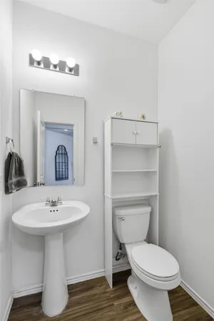 a bathroom with a sink toilet and a mirror