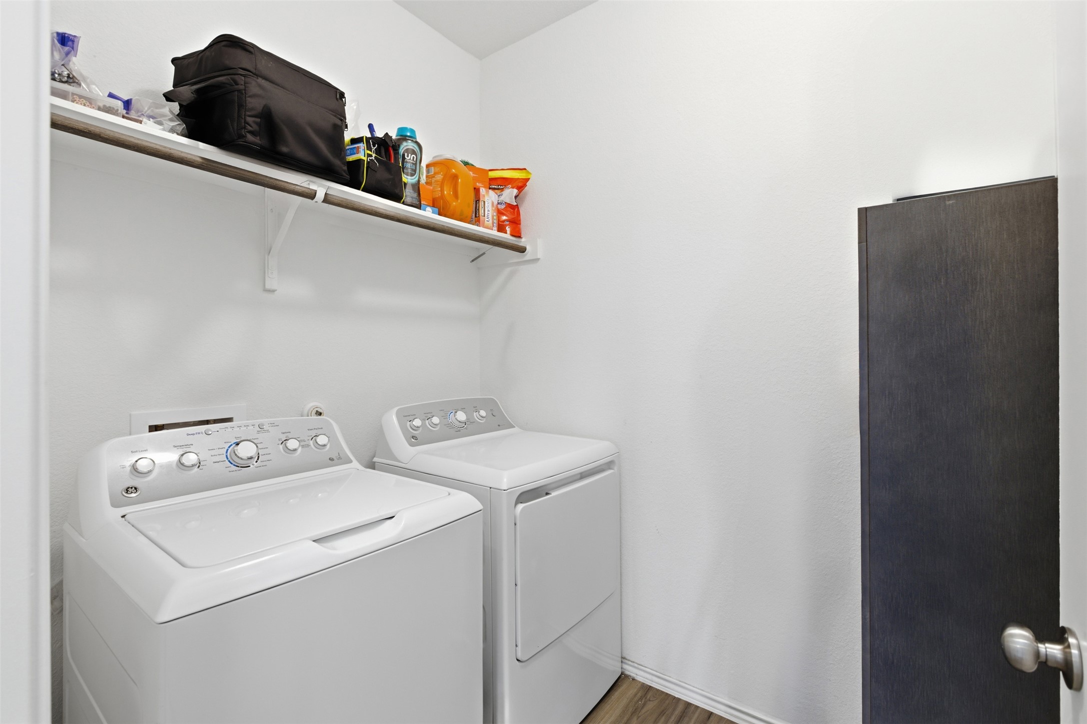 832 Mallow Road Leander, TX 78641 - Photo 24 of 29 Laundry area with washer and clothes dryer and dark wood-type flooring