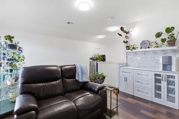 a living room with furniture and flowers