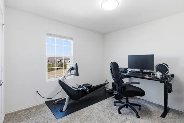 a work room with furniture and a window