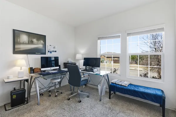 a workspace with a window and lounge chair