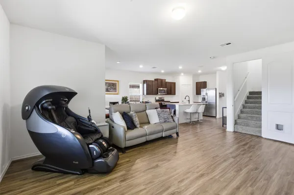 a living room with furniture and wooden floor