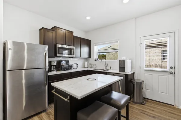 a kitchen with refrigerator cabinets and wooden floor