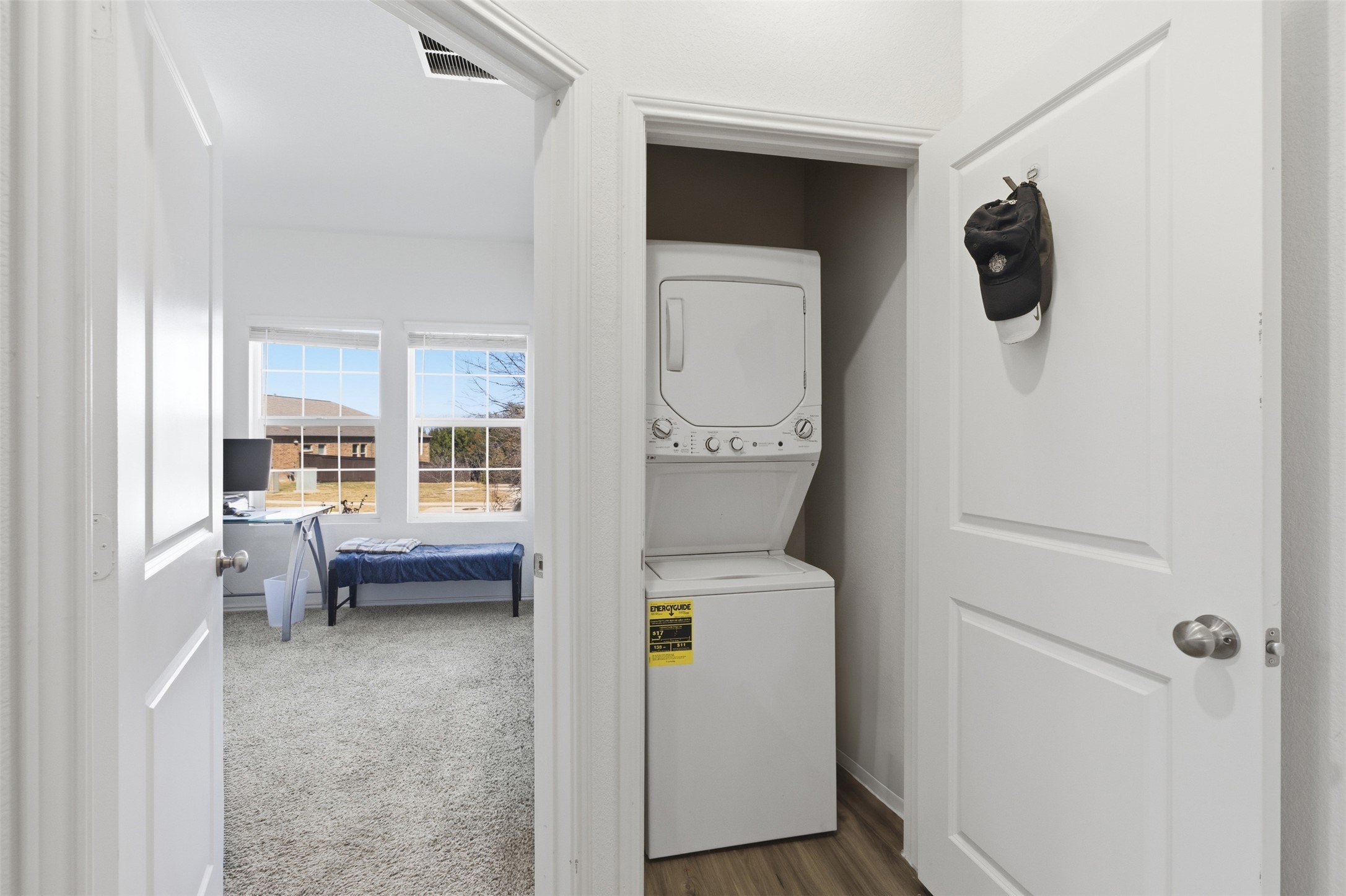 832 Mallow Road Leander, TX 78641 - Photo 10 of 29 NextGen Suite Laundry area with stacked washer and clothes dryer and carpet floors