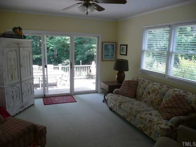 2918 Hostetler Street Raleigh, NC 27609 - Photo 8 of 10 The bright and cheery family room has 3 sides of windows, including that slider to the huge deck.