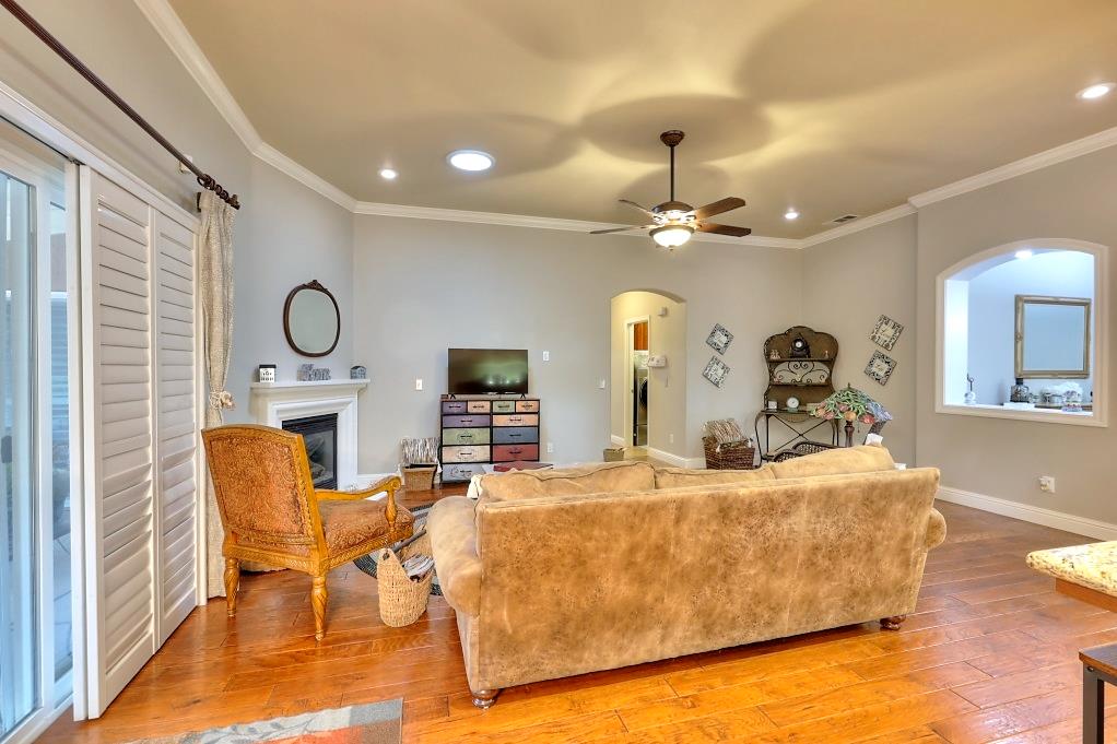 4152 Post Oak Drive Turlock, CA 95382 - Photo 37 of 71 a living room with fireplace furniture and a wooden floor