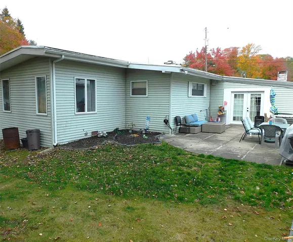 a backyard of a house with table and chairs