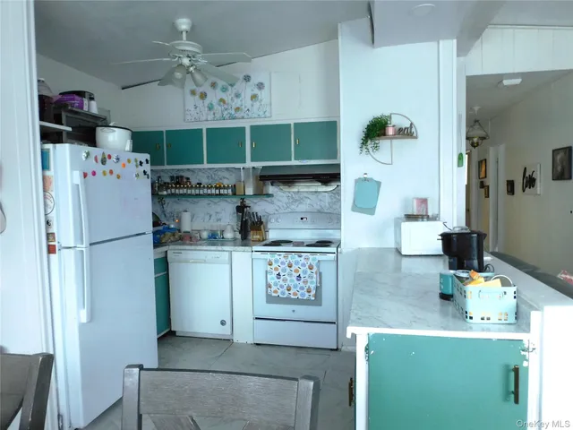 a kitchen with a refrigerator and a stove