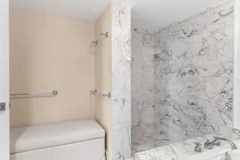 a balcony with wooden floor and outdoor seating