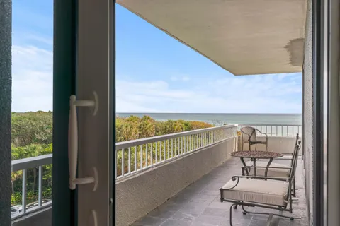 a view of a balcony with chairs