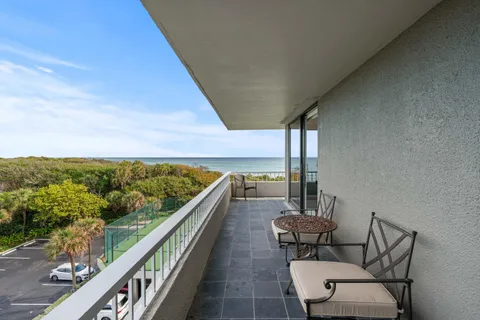 a view of a balcony with chairs