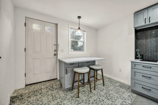 a kitchen with a refrigerator a stove a microwave and white cabinets