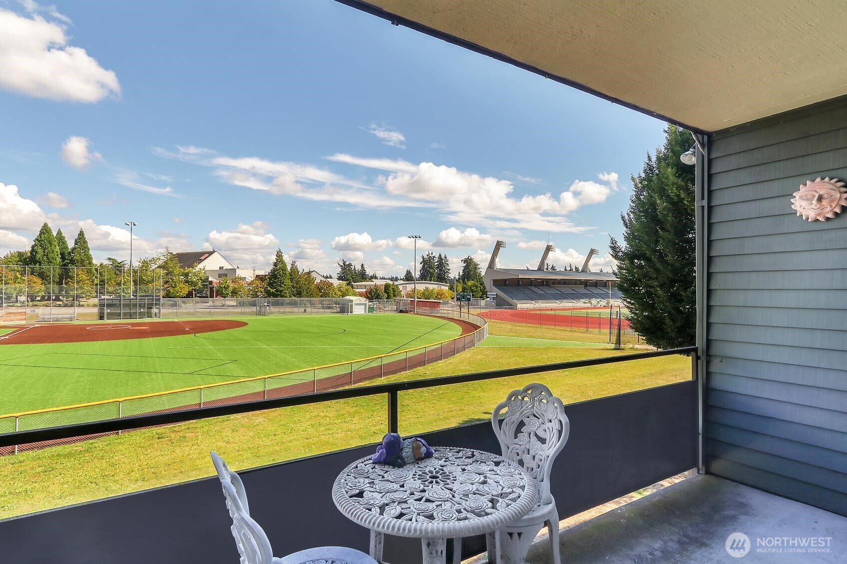 a view of a swimming pool with a chairs and table in the patio