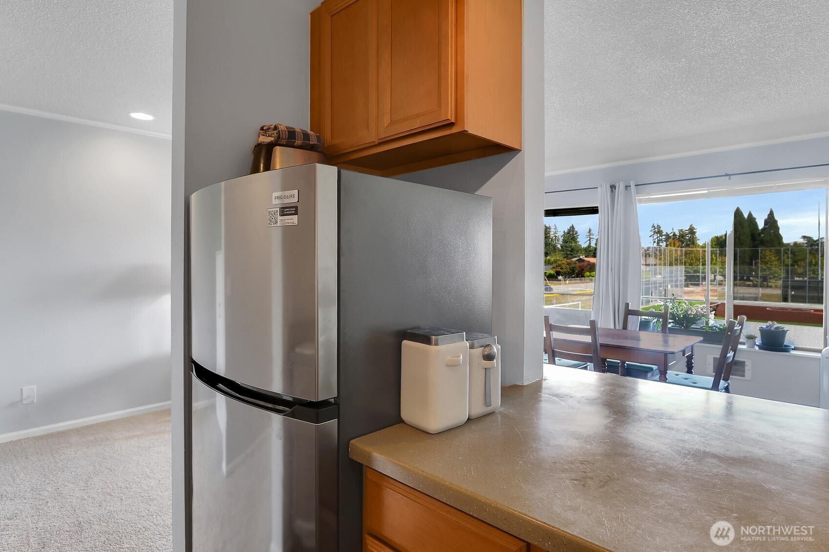 7924 212th Street Southwest, Unit 211 Edmonds, WA 98026 - Photo 8 of 14 a view of kitchen with furniture and refrigerator