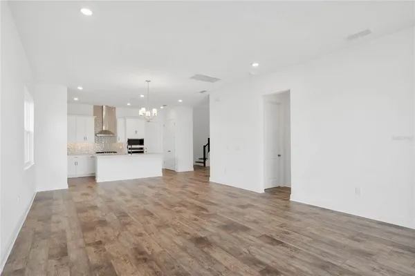 a view of kitchen with kitchen island sink and refrigerator