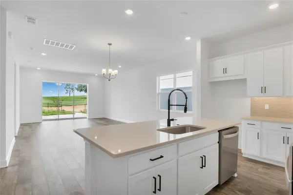 a kitchen with a sink cabinets and window