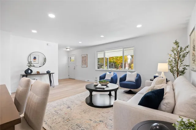 a living room with furniture and a potted plant