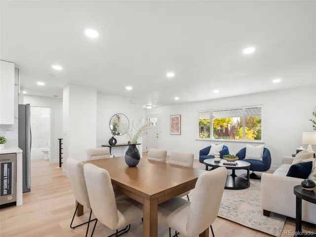 a living room with lots of furniture and a large window